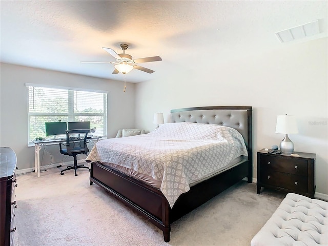 bedroom with ceiling fan and light carpet