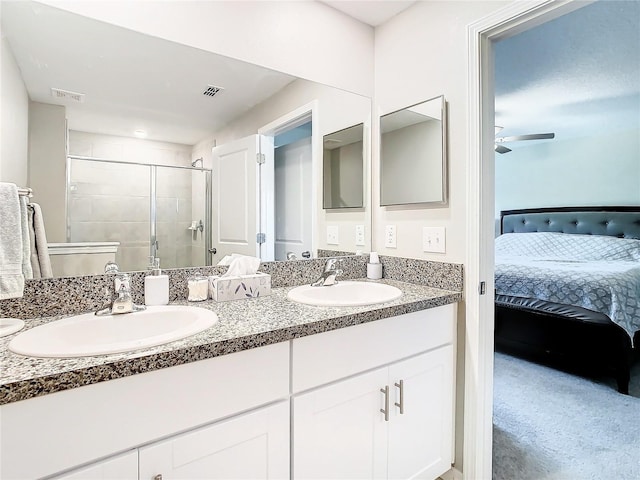 bathroom featuring ceiling fan, double sink vanity, and walk in shower