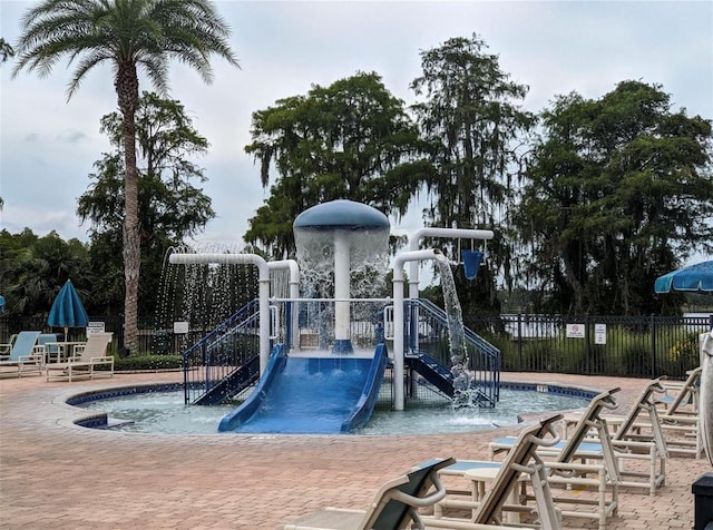 view of jungle gym with a community pool and pool water feature