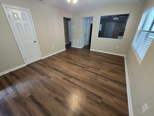 unfurnished bedroom featuring dark wood-type flooring