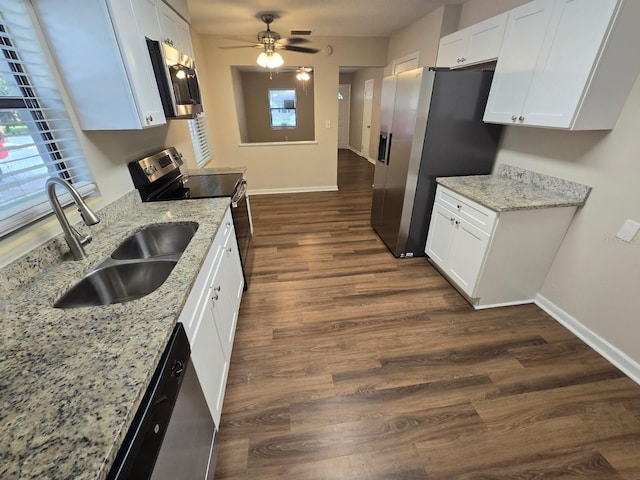 kitchen featuring sink, dark hardwood / wood-style flooring, white cabinetry, appliances with stainless steel finishes, and ceiling fan