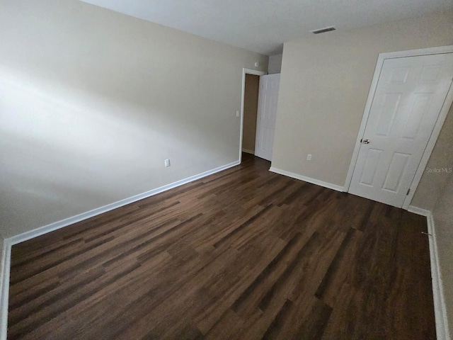 unfurnished bedroom featuring dark hardwood / wood-style flooring