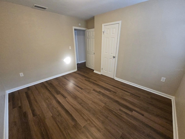 unfurnished room featuring dark hardwood / wood-style flooring