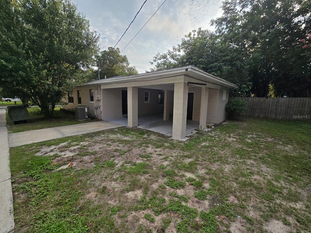 exterior space featuring central AC and a lawn