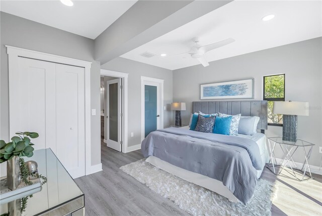 bedroom featuring ceiling fan, a closet, and light wood-type flooring