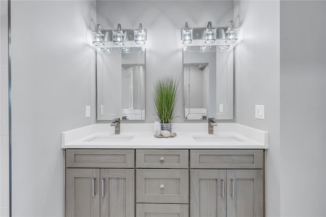 full bathroom with double vanity and a sink