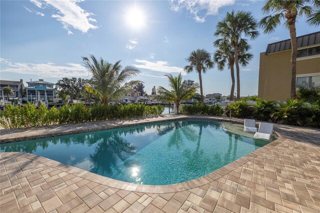 outdoor pool with a patio area