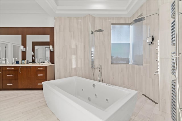 bathroom featuring a whirlpool tub, double vanity, walk in shower, and a raised ceiling