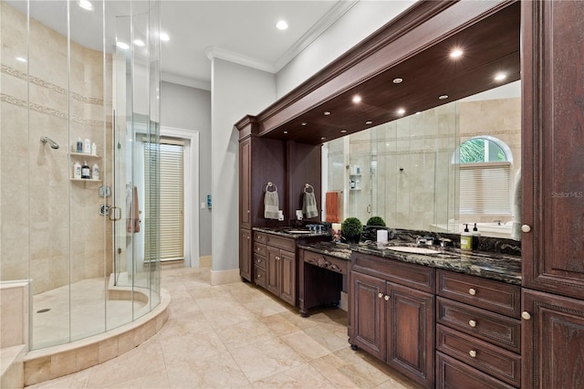 bathroom with a stall shower, ornamental molding, two vanities, and a sink