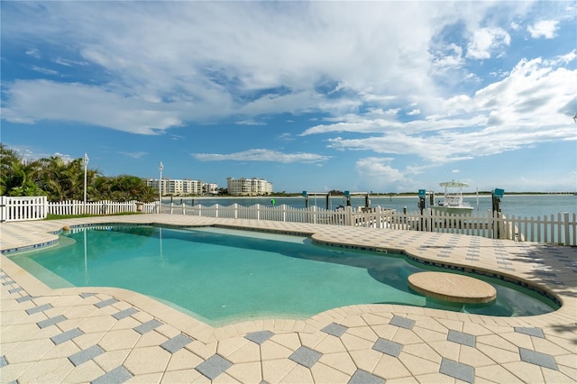 view of swimming pool featuring a water view, a patio area, fence, and a fenced in pool