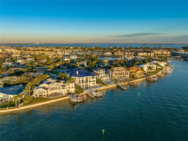 drone / aerial view with a water view and a residential view