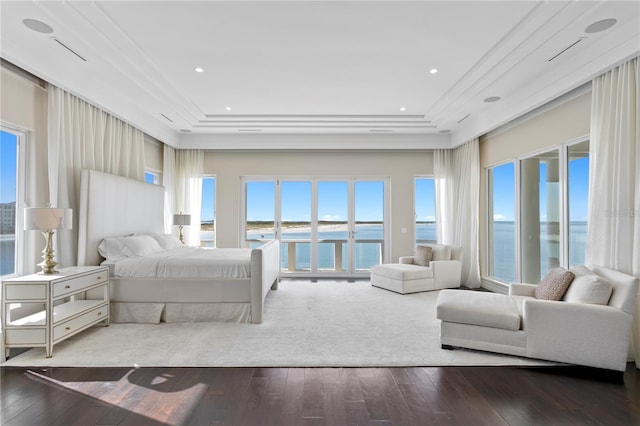 bedroom with access to outside, a water view, and hardwood / wood-style floors