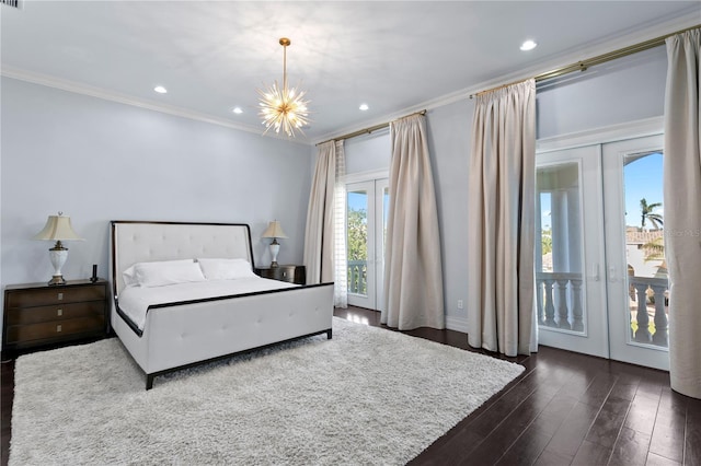 bedroom with dark wood-style floors, french doors, crown molding, recessed lighting, and a chandelier