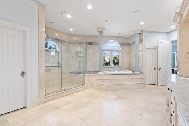 full bath featuring a sink, a stall shower, a garden tub, and recessed lighting