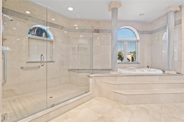 full bathroom featuring a stall shower, ornate columns, and a bath