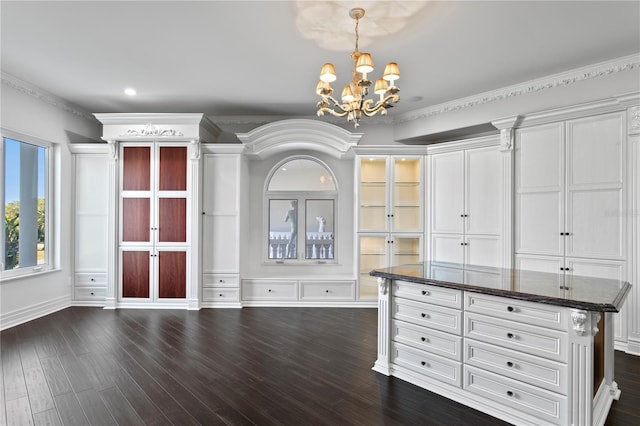 unfurnished dining area with ornamental molding, dark wood-type flooring, a notable chandelier, and recessed lighting