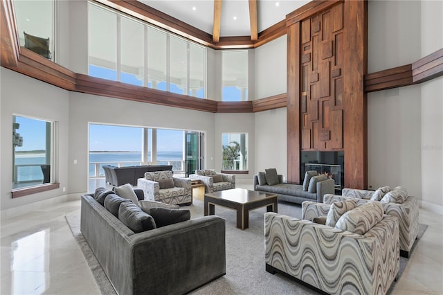 living room with a towering ceiling and baseboards