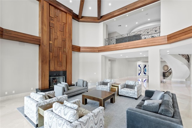 living area featuring baseboards, a high ceiling, and recessed lighting