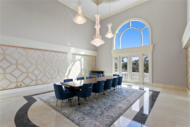 dining space featuring marble finish floor, an accent wall, french doors, and baseboards