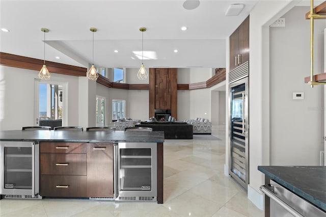 kitchen featuring dark countertops, beverage cooler, modern cabinets, and recessed lighting