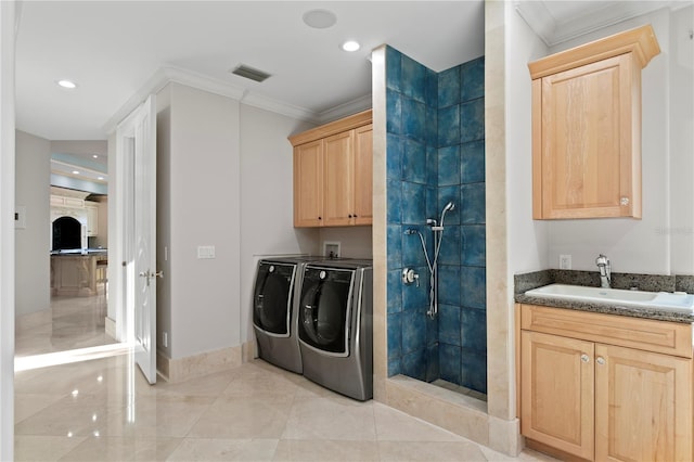 laundry area with a sink, visible vents, independent washer and dryer, cabinet space, and crown molding