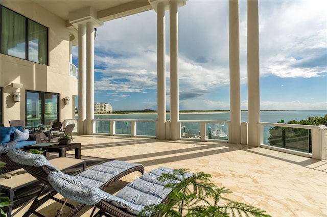 view of patio with a water view