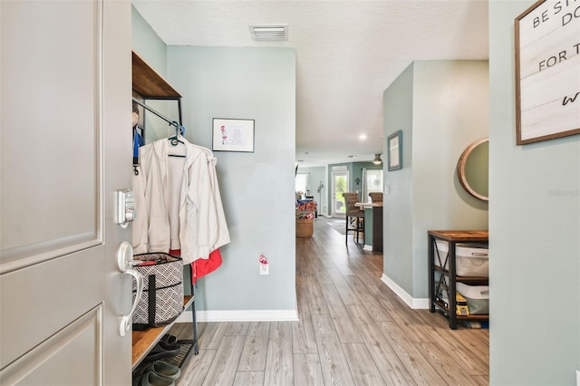 interior space featuring light hardwood / wood-style floors and a textured ceiling