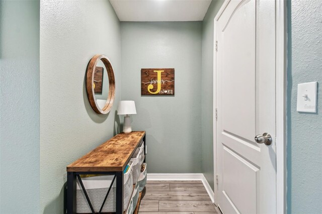 doorway to outside with wood-type flooring