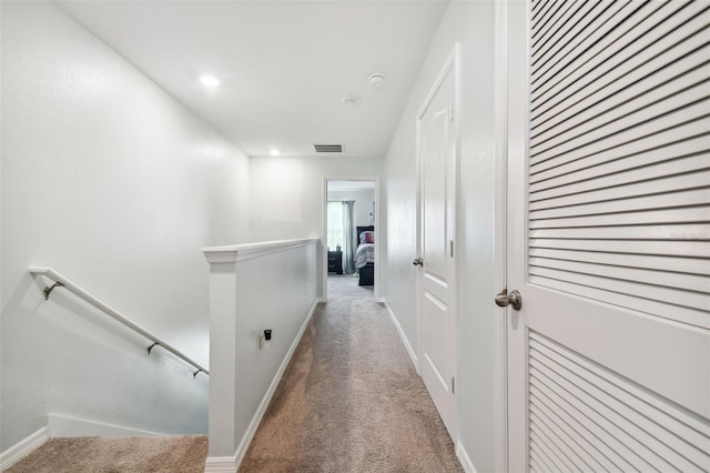 corridor with light colored carpet