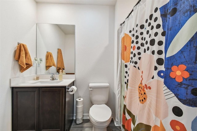 bathroom with toilet, vanity, and a shower with curtain