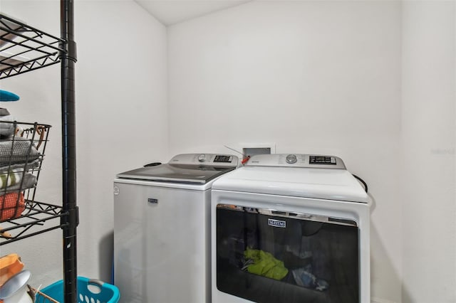 clothes washing area with independent washer and dryer