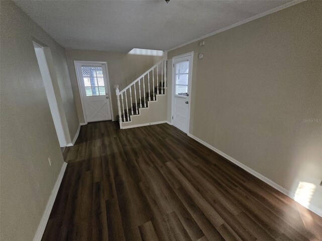 interior space with crown molding and dark hardwood / wood-style flooring