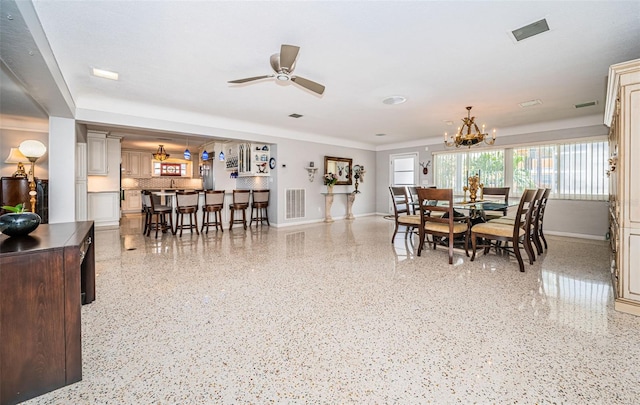 dining space with ceiling fan with notable chandelier