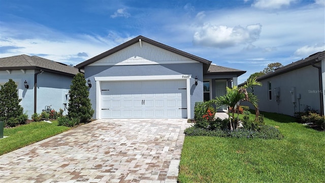 ranch-style home with a front lawn and a garage