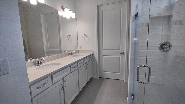 full bathroom with tile patterned flooring, a stall shower, double vanity, and a sink