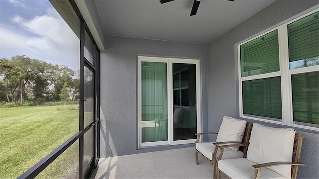 sunroom / solarium with a ceiling fan