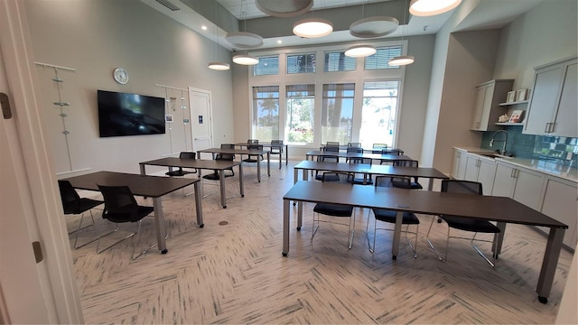 dining space featuring a high ceiling