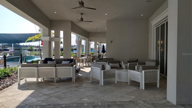 view of patio featuring an outdoor pool, an outdoor hangout area, and ceiling fan