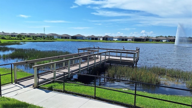 dock area with a residential view and a water view