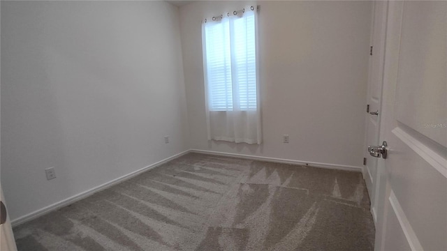 carpeted spare room with baseboards and a healthy amount of sunlight