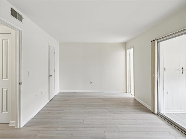 spare room with light hardwood / wood-style flooring