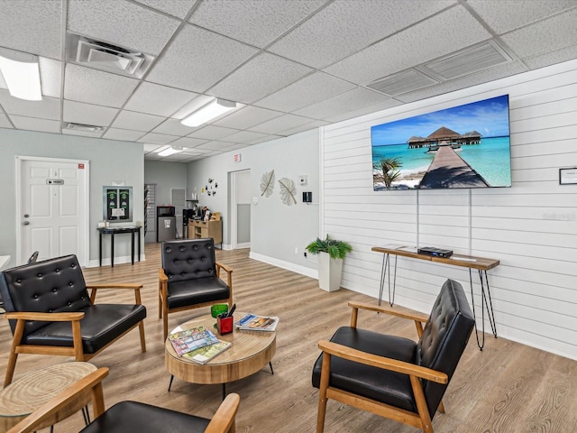 interior space with light hardwood / wood-style floors and a drop ceiling