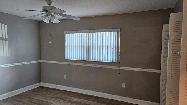 spare room featuring ceiling fan, wood-type flooring, and a textured ceiling