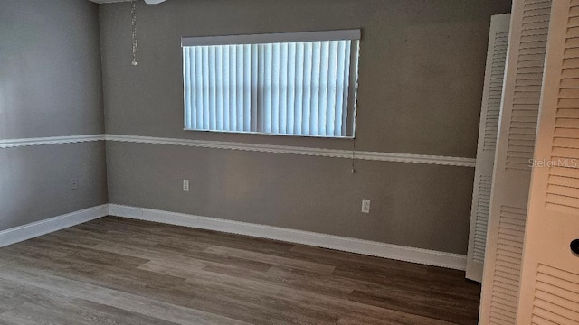 empty room with a healthy amount of sunlight and wood-type flooring