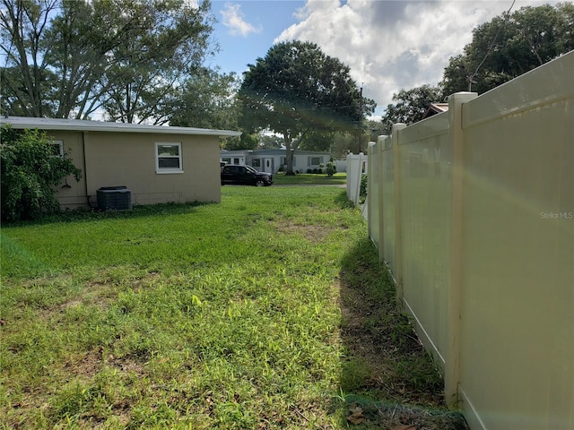 view of yard featuring central air condition unit