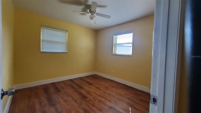 empty room featuring dark hardwood / wood-style flooring and ceiling fan