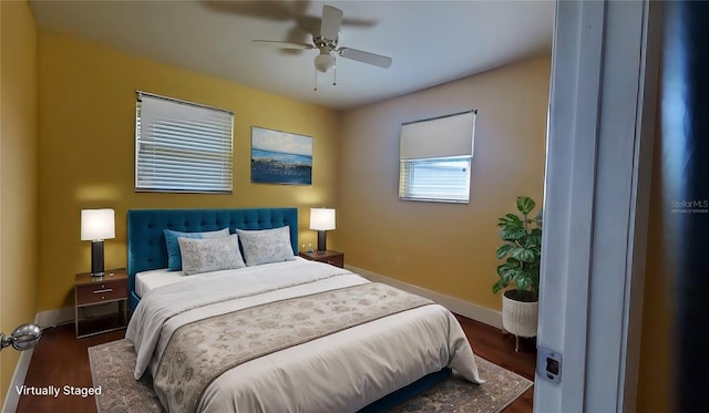 bedroom with ceiling fan and dark hardwood / wood-style floors