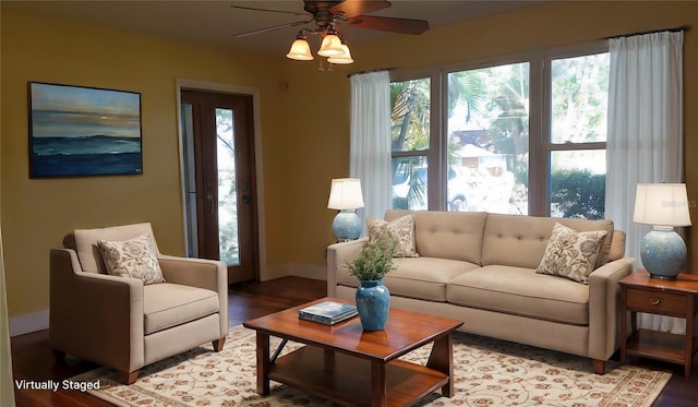 living room featuring hardwood / wood-style floors and ceiling fan