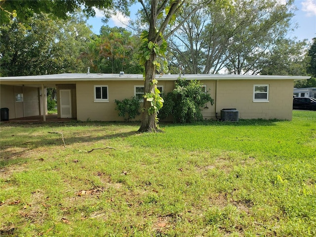 rear view of house featuring a yard and cooling unit