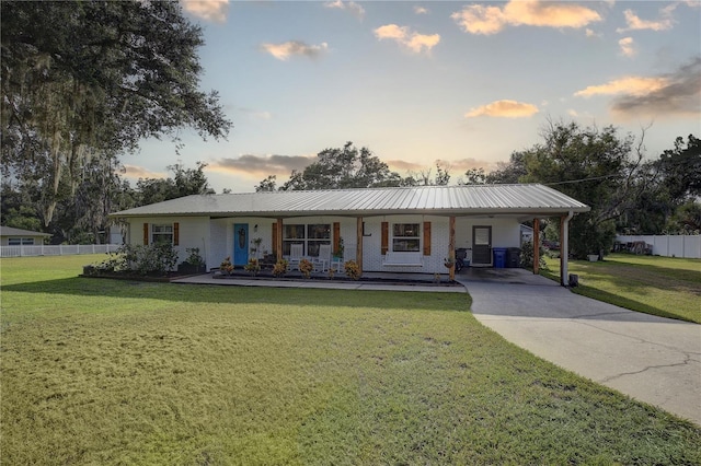 view of front of property with a lawn, a carport, and a porch